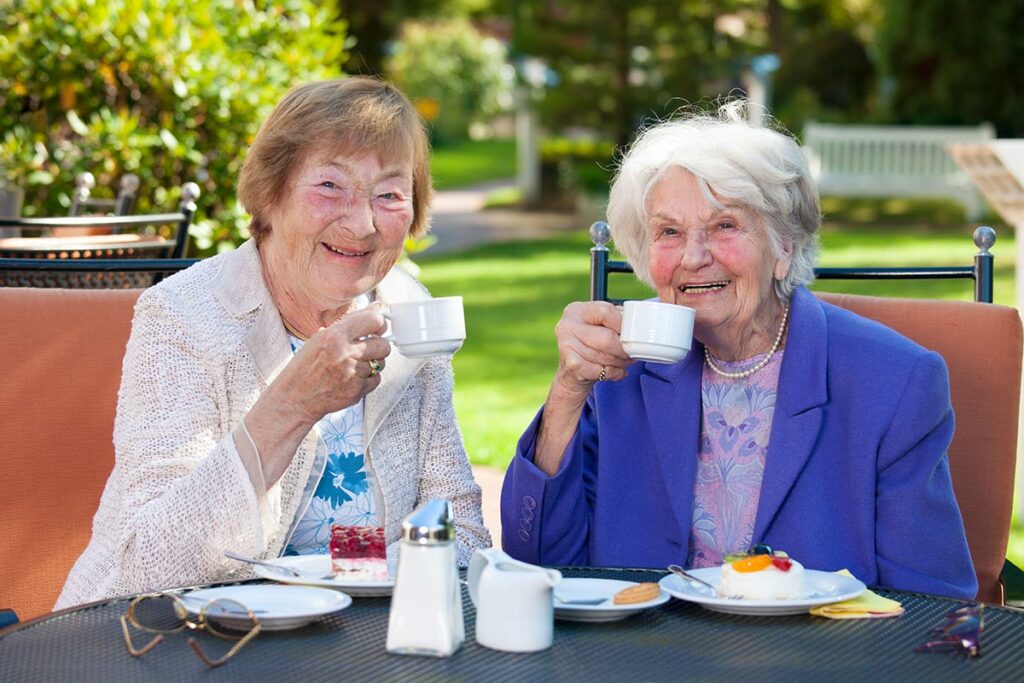 Dominion of Athens | Senior women eating desserts