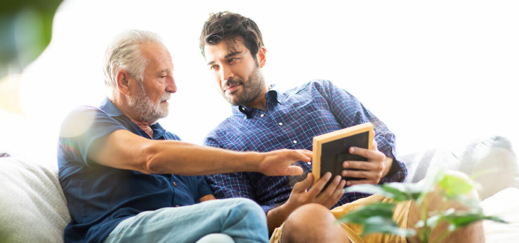 Dominion of Bristol | Senior man and his son looking and discussing a picture