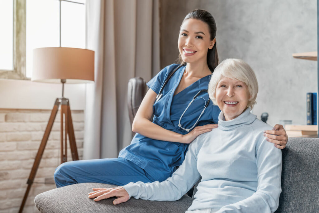 Dominion of Frankfort | Senior woman sitting on a couch with her caregiver