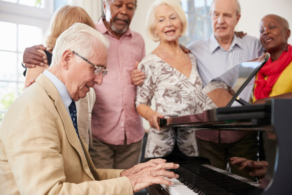 Dominion of Frankfort | Seniors sing around a piano