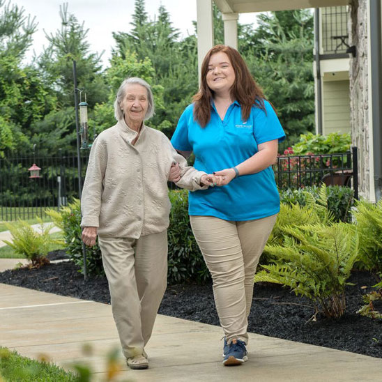 Dominion of Johnson City | Resident walking with associate