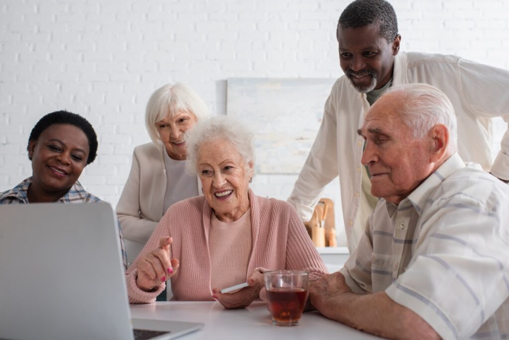 Dominion Richmond | Group of seniors socializing around a computer