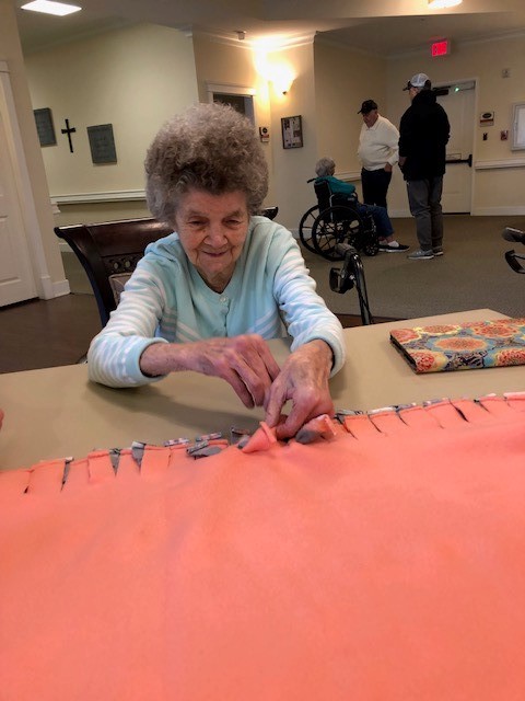 Dominion of Sevierville | Resident making blanket