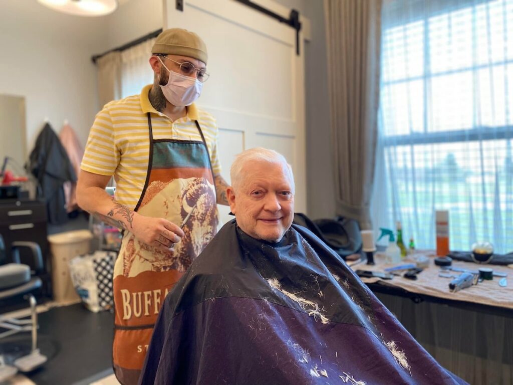 Dominion of Frankfort | Resident getting his hair cut by a local barber